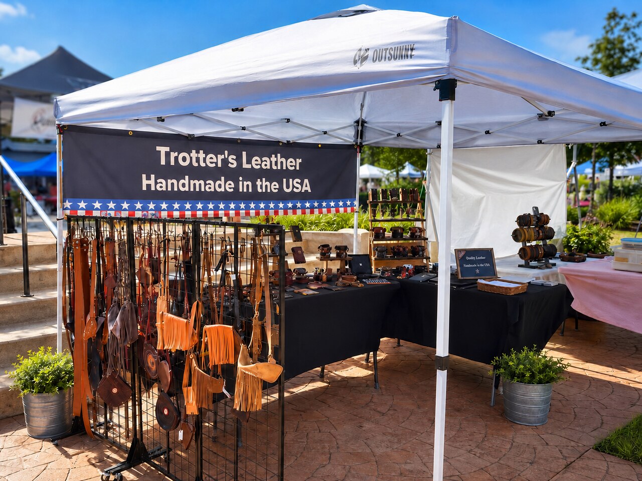 Trotter’s Leather market booth with handmade leather products displayed